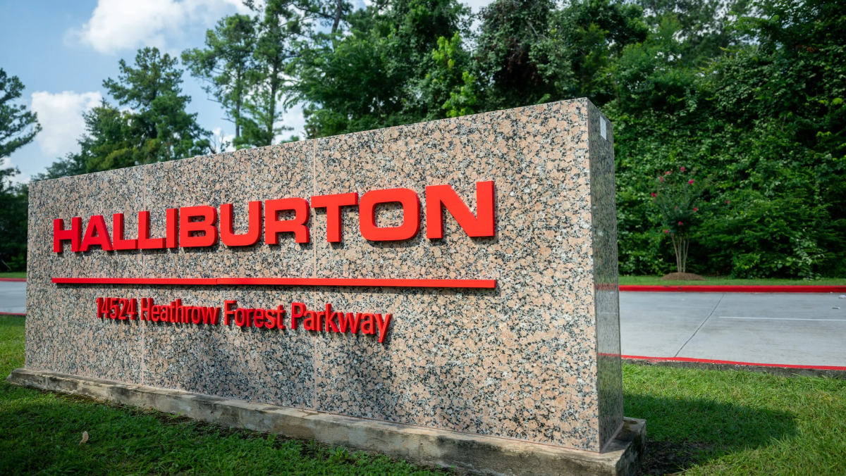 Halliburton sign displayed on a stone monument in front of greenery.